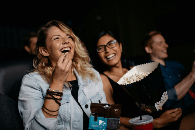Two women laughing at a cinema screening