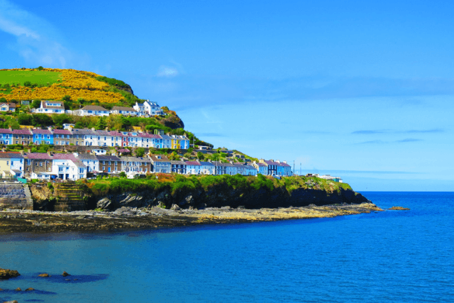 Views of the colorful houses of New Quay along the coast