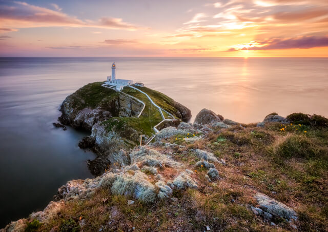 South Stack Lighthouse in Holyhead with a sunset.