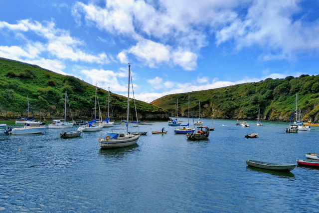 Solva harbour surrounded by green hills and blue skies